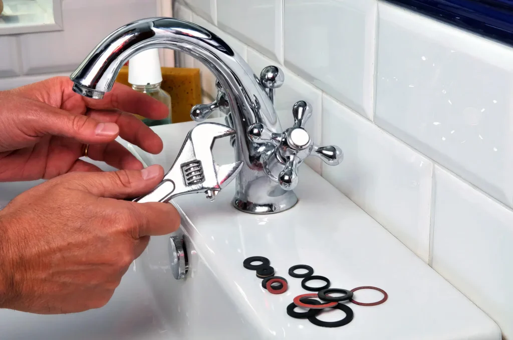 Plumber performing maintenance on a bathroom faucet in Springfield