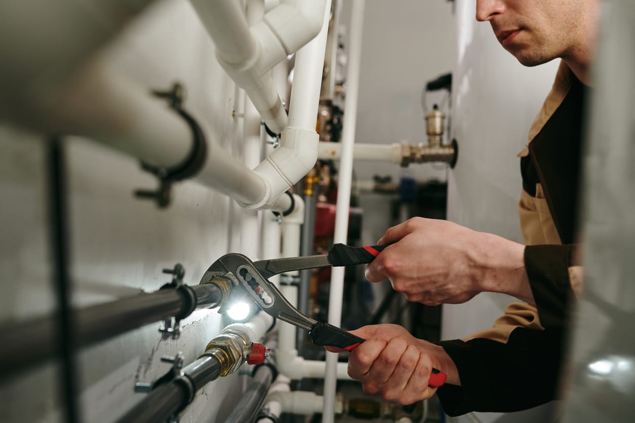 Plumbers maintaining commercial plumbing pipes in Springfield