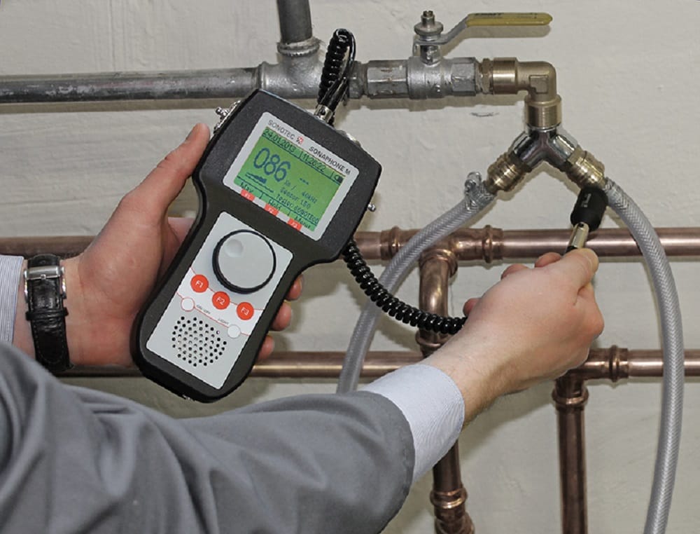 Plumber testing pipes with electronic leak detection equipment in Springfield
