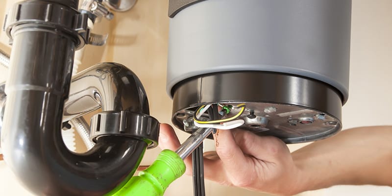 Technician repairing the heating element of a water heater in Springfield