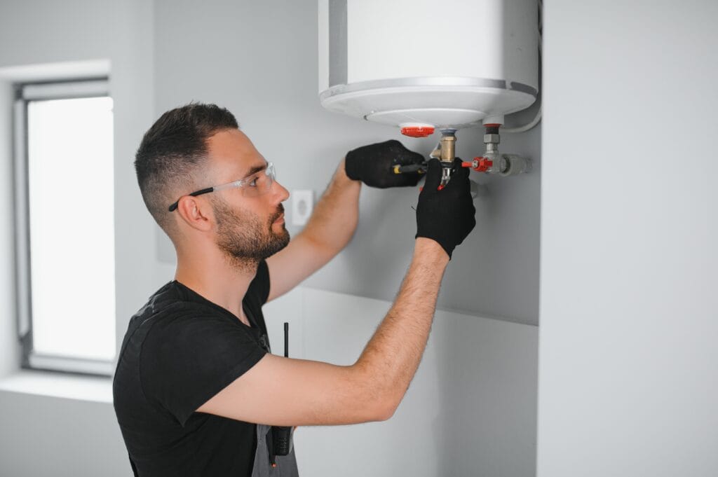 Technician performing water heater maintenance in Springfield
