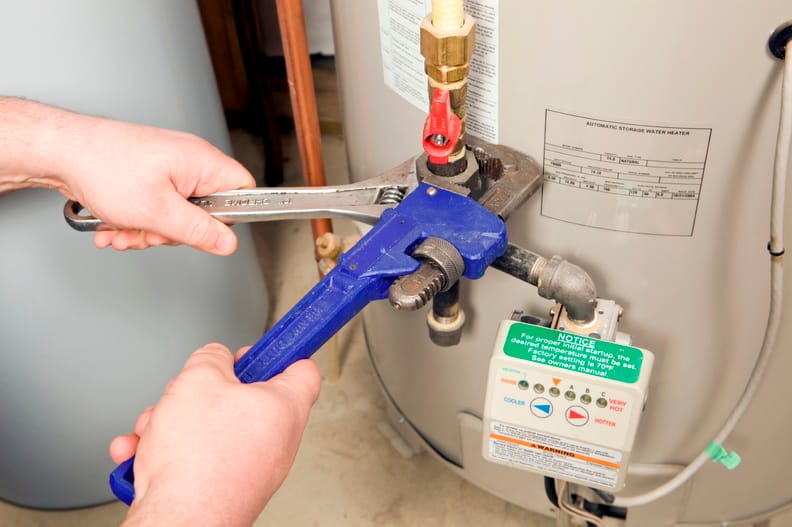 Plumber repairing a water heater valve in Springfield
